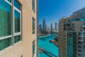 迪拜Splendid Apartments with Burj Khalifa and Fountain View的两座高楼之间的河流景观