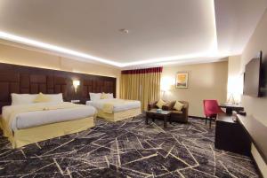 穆里Ramada by Wyndham Murree Lower Topa Resort的酒店客房设有两张床和电视。