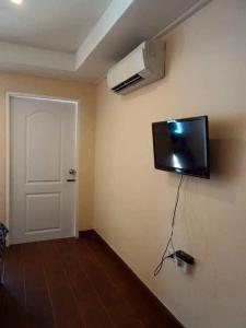 阁遥岛Baan Gebsup บ้านเก็บทรัพย์的墙上配有平面电视的房间