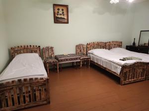 BerdavanBerdavan Guesthouse的铺有木地板的客房内的两张床
