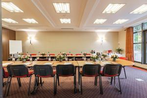 安东尼德贝尔尼酒店的大型会议室,配有大桌子和椅子