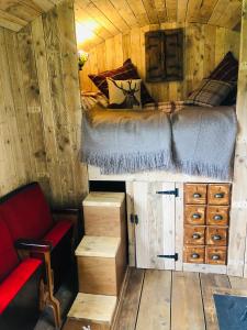 查尔伍德The Big Green Shepherds Hut的小木屋内一间卧室,配有一张床