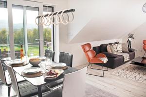 罗拉赫BlackNCozy - Design Appartement mit Boxspringbett und Balkon的一间带桌椅和沙发的用餐室