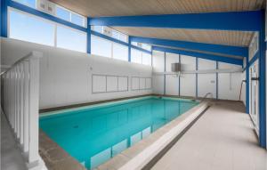 内克瑟Lovely Apartment In Nex With Sauna的一座位于大楼内的蓝色海水室内游泳池