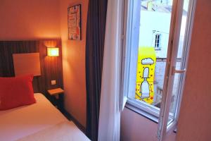 昂热Logis Hôtel Marguerite d'Anjou的一间卧室配有一张床,外面设有一扇窗户,窗户外设有黄色的汽车