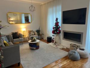 塞图巴尔La Petit Maison的客厅配有圣诞树和电视