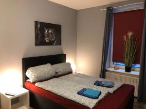 弗伦斯堡Flensburg City - 24h的小卧室配有一张带毯子的床
