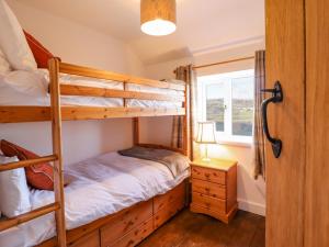 兰戈伦Alwyn Cottage的一间卧室设有两张双层床和一扇窗户。