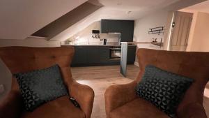 伦敦德里CHAMBERS RISE - City Centre Stays的一间带两把椅子的客厅和一间厨房