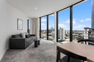 墨尔本Adina Apartment Hotel Melbourne Southbank的客厅配有沙发和桌子