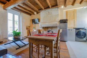 Balnot-sur-LaignesGîte le Champenois的厨房配有木桌、椅子和炉灶