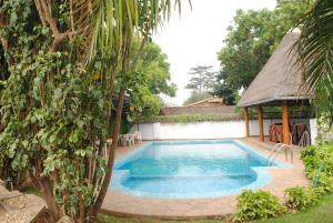 布琼布拉Kiriri Residence Hotel的一个带凉亭的庭院内的游泳池