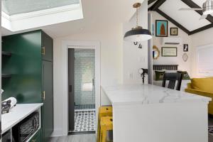 夏洛特The Cozy Yellow Cottage in Dilworth的厨房配有绿色和白色的台面