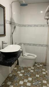 Tân HộiHoàng Nam Hotel的浴室配有盥洗盆、卫生间和浴缸。