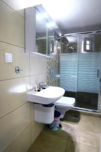 兹拉马Ourania Apartment的浴室配有白色水槽和淋浴。