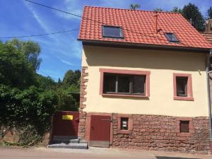 ElmsteinFerienhaus In der Erlebach的红色屋顶和红色门的房子