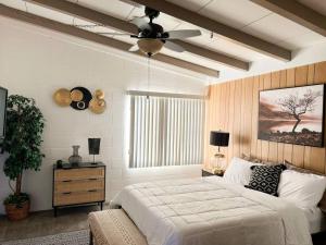 二十九棕榈村Joshua Tree National Park - Cozy Palms Getaway的一间卧室配有一张床和吊扇