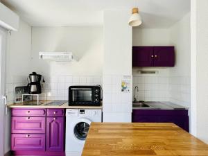 康博莱班Appartement Cambo-les-Bains, 2 pièces, 2 personnes - FR-1-495-46的厨房配有紫色橱柜和微波炉