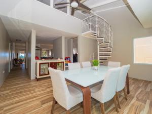 里奥格兰德Newly Renovated 8 Bedroom Ocean Front Villa with Pool的一间带桌椅的用餐室和螺旋楼梯