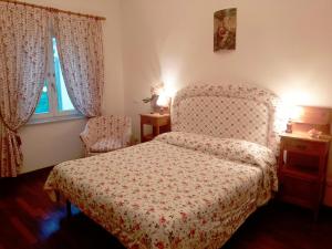 比萨Il Campanile II Locazione Turistica的卧室配有床、椅子和窗户。