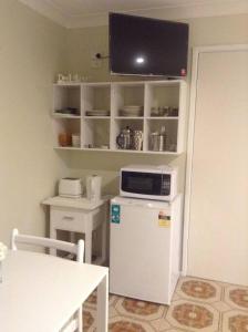 福斯特Seascape的厨房配有小型白色冰箱和桌子