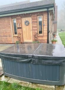 BramleyQuality Oak Barn with Hot Tub and Parking的房屋前的大浴缸