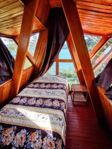 托塔Refugio Génesis habitaciones Lago de Tota的小木屋内一间卧室,配有两张床