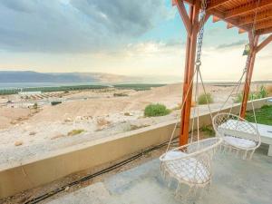 OvnatCharming unit in Dead Sea的一个带两把椅子的门廊,享有沙漠的景色