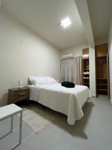 埃斯特城Cerca de todo的一间白色卧室,配有一张床和一个衣柜