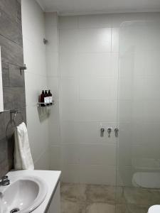 圣拉斐尔Departamento Hilario的带淋浴和盥洗盆的白色浴室