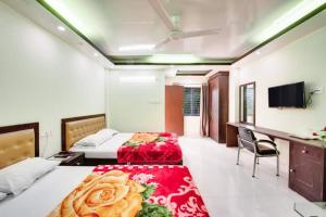 BāndarbanHill Crown Hotel & Resort的一间卧室配有两张床、一张桌子和一台电视。