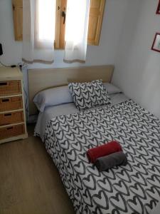 埃尔卡斯蒂略德拉斯瓜尔达斯Villa Saudade, casa entre encinas的一间卧室配有一张红色枕头的床