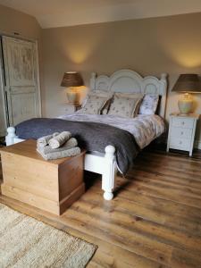 贝克尔斯Beehive Cottage的一间卧室配有一张带两盏灯的大型白色床。