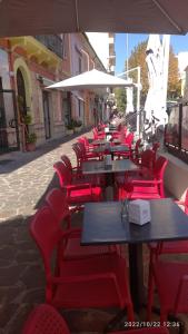 托尔托拉Beb Alla Marina Tortora的庭院里一排桌子和红色椅子