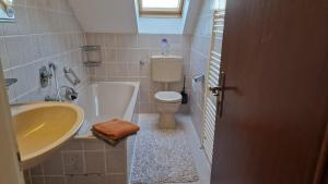 曼海姆Cheerful Roof Flat in a Private German Style House的一间带水槽、浴缸和卫生间的浴室