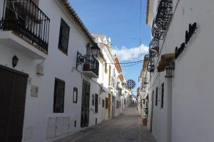 阿尔啼La Cueva的一条白色建筑和蓝天的小巷