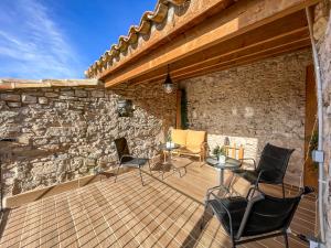 莱里达El Forn de Freixenet con servicios de un hotel的一个带桌椅的庭院和石墙