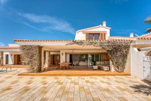 萨尔加LA CALMA Espectacular villa con jardín y piscina en Menorca的一座带庭院和房子的别墅