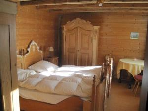 巴特欣德朗Knusperhäusle Reckenberg的木制客房内的一间卧室配有一张大床