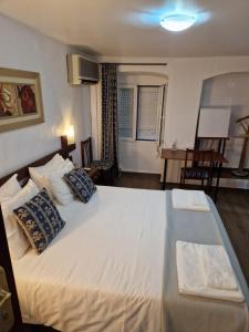 埃尔瓦斯Residencial Antonio Mocisso Guesthouse的卧室配有带枕头的大型白色床