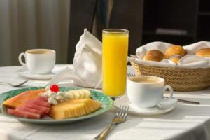 墨西哥城Hotel Real del Sur的一张桌子,上面放着一盘食物和一杯橙汁