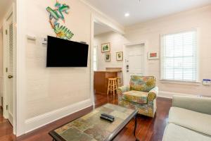 基韦斯特Palm Gardens的客厅的墙上配有平面电视。