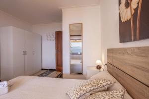 阿尔库迪亚Apartamento Voramar 101 in Alcudia的一间卧室配有一张大床和镜子