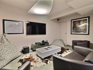 莱热Chalet Les Gets, 7 pièces, 12 personnes - FR-1-627-6的客厅配有沙发、椅子和电视