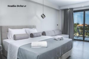蒂锡利维Dionisos Luxury Suites的一间卧室配有一张大床和毛巾