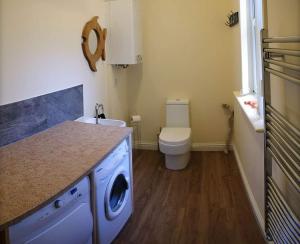 EdinbainOwlswood Apartments的一间带洗衣机和卫生间的浴室