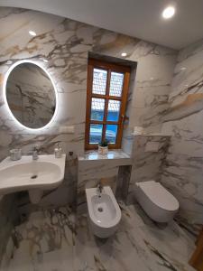 奈达Vila Kopa Nida的一间带水槽、卫生间和镜子的浴室