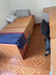 潘普洛纳Habitación cómoda a 10 minutos del centro的一间卧室配有一张床、一张桌子和一把椅子