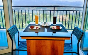 伊都基10 Degrees North By Avni Holidays的阳台上的一张桌子上放着两盘食物