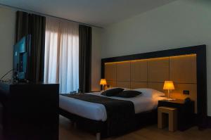 博尔加罗托里内塞B&B Hotel Borgaro Torinese的一间卧室配有一张大床和大床头板